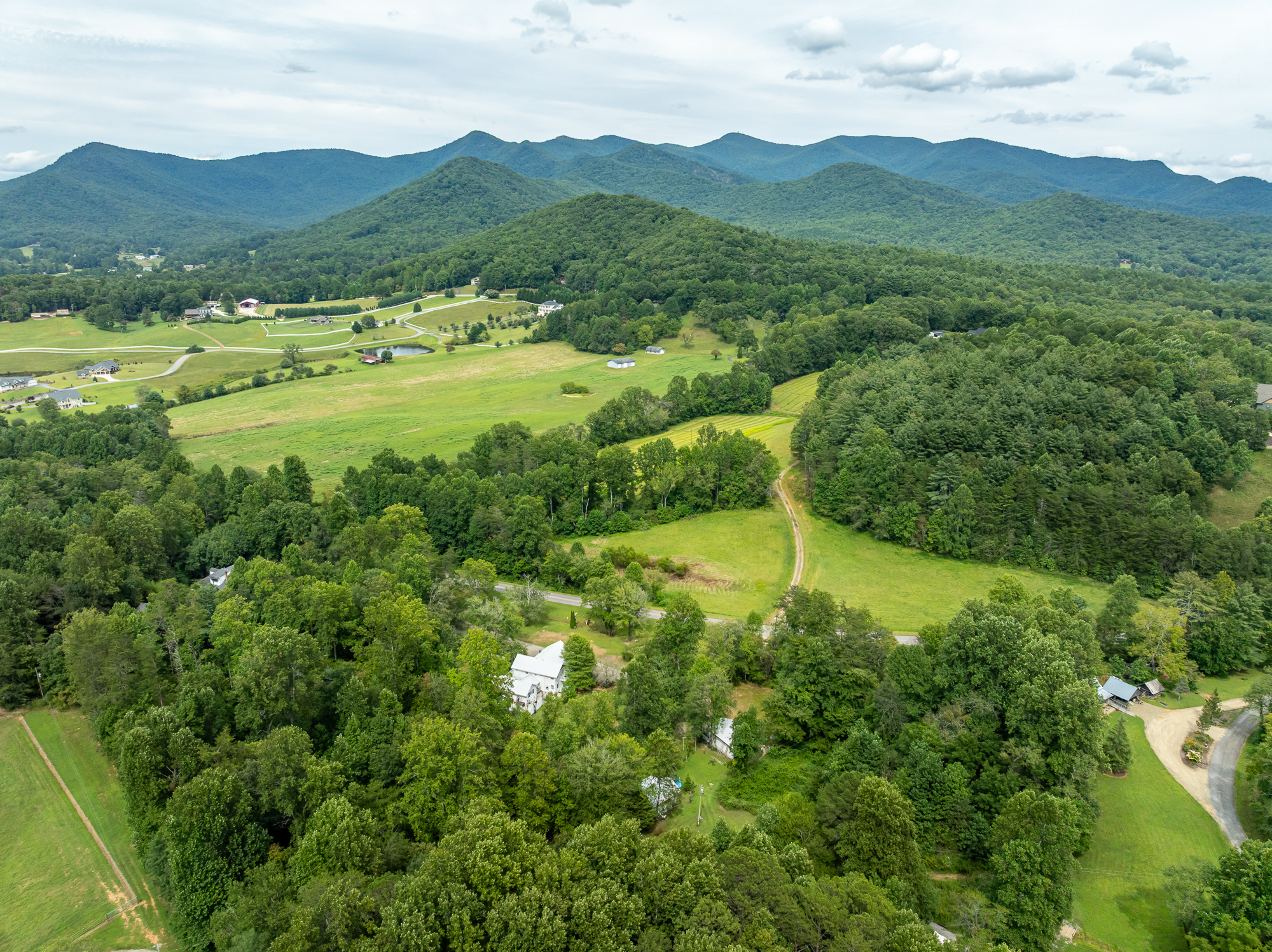 An aerial view of a valley road winding through the North Georgia mountains