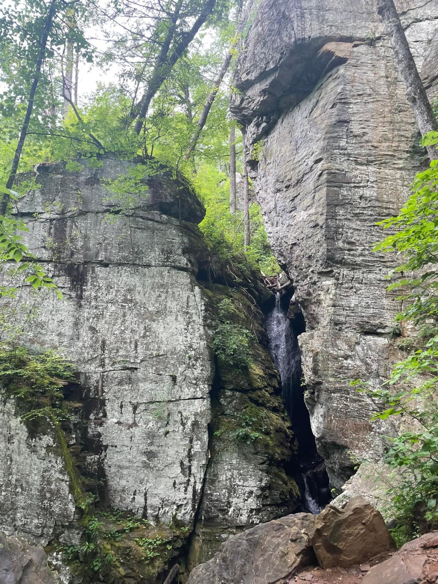 A waterfall running through a narrow rock crevice near Misty Mountain
