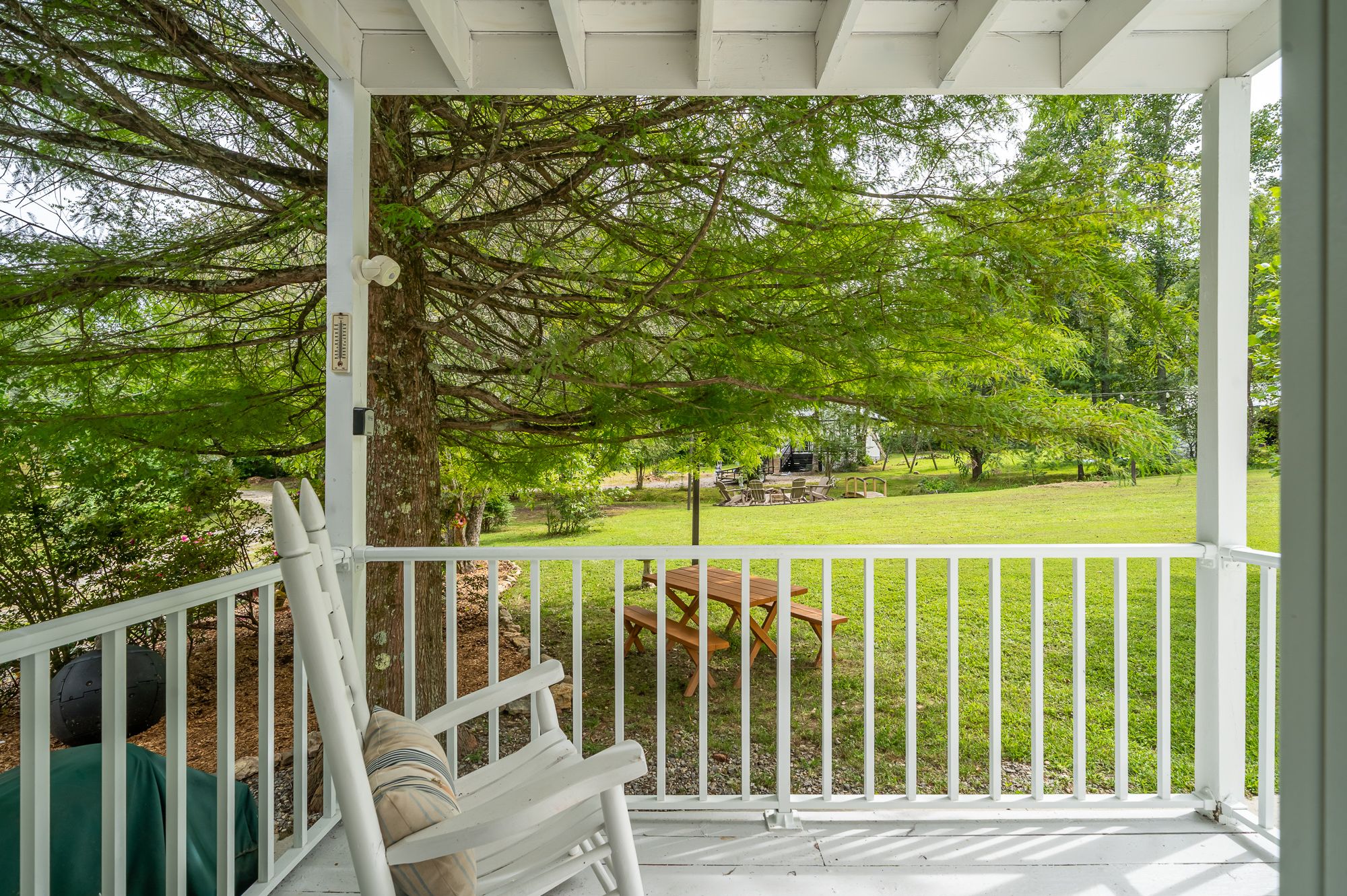 The covered porch outside the Appalachian room, with rocking chairs looking out at the lawn