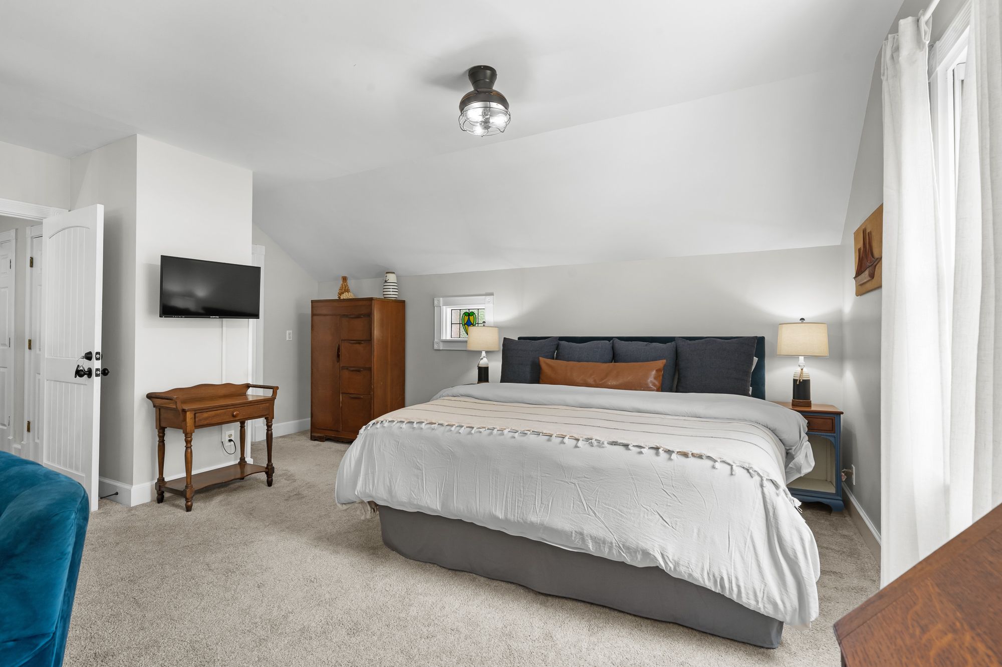 The Seafarer room at Trackrock Hollow Lodge, with a king bed under a sloped ceiling