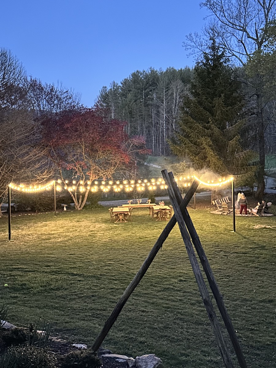 Guests gathered around the communal firepit at dusk
